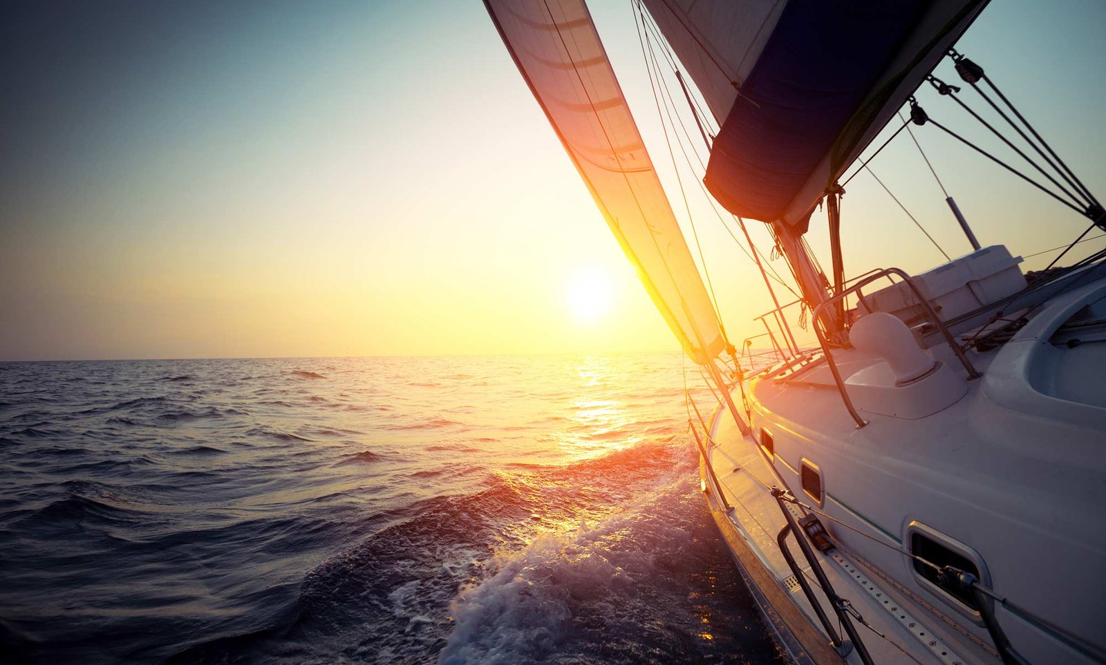 Beautiful yacht with sunlight in the distance over water